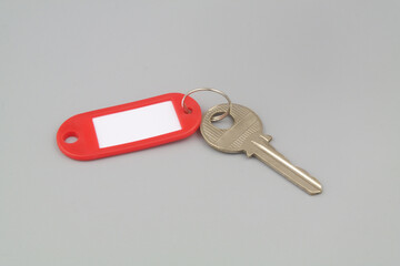 Key with label on gray background. Real estate business concept.	
