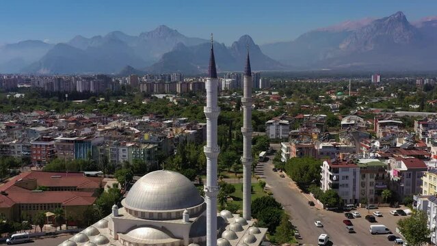 White Mosque, Cityscape and Mountains. Antalya, Turkey. Aerial View. Drone Flies Backwards and Upwards