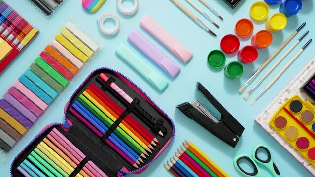 Back to school concept. Colorful school supplies placed on blue background