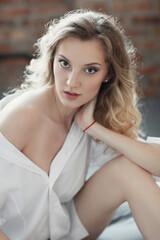 Relaxing at Home: A Blonde Woman Captured in Various Poses in Bed and the Kitchen