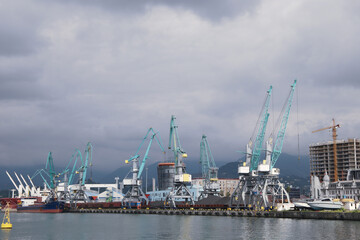 Fototapeta na wymiar cargo cranes in the water area of the port of Batumi