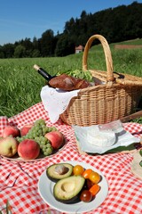 A picnic is nature, friends and deliciousness (fried sausages, potatoes and ripe tomatoes, cucumbers, avocados and cold wine)