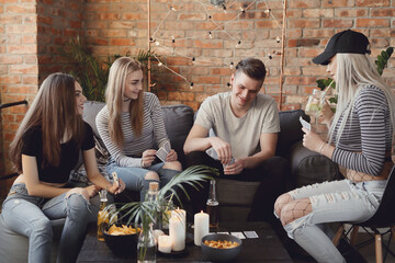 Get the party started with this fun and vibrant stock photo of a group of people enjoying food and drinks in the kitchen.