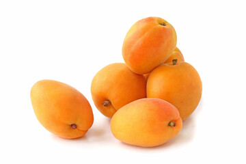 Several big flat apricots isolated on white