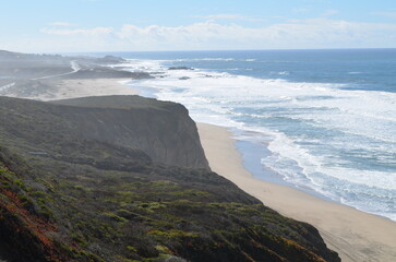 View of road and wide sandy beach on Californian Pacific coast