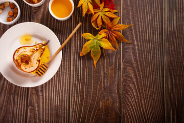 Obraz na płótnie Canvas Honey or maple syrup roast pears with walnuts. Vegetarian diet health delicious dessert.