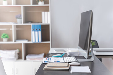 Stylish workspace with desktop computer and office supplies in business office.
