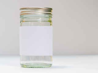 silver screw top glass jar with clean white label