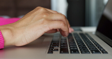 Close up of woman hands typing on laptop computer keyboard and surfing the internet on office table, online, working, business and technology, internet network communication concept.