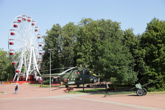 Vitebsk , Belarus &ndash; 08 22 2022: Ferris wheel, Helicopter and cannon in Winners Park at summer day 