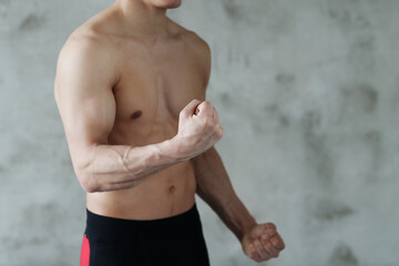 Obraz premium Handsome Young Middle Eastern Male Athlete Warming Up Before Training At Gym, Preparing For Fitness Workout In modern Sport Club, Copy Space