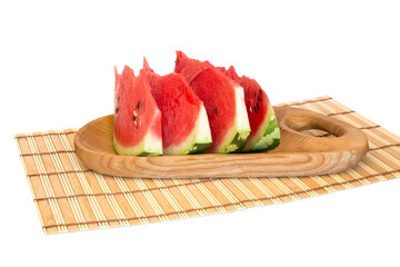 Slices of watermelon on a wooden board on a napkin isolated on white