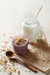 Homemade cooked healthy granola for breakfast in a wooden bowl on the table and near a bottle of milk. Place for text. Fitness food, snack