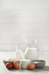 Homemade cooked healthy milk products for breakfast in a wooden bowl on the table and near a bottle of milk. Place for text. Fitness food, snack