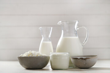 Homemade cooked healthy milk products for breakfast in a wooden bowl on the table and near a bottle of milk. Place for text. Fitness food, snack