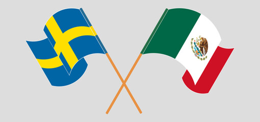 Crossed and waving flags of Sweden and Mexico