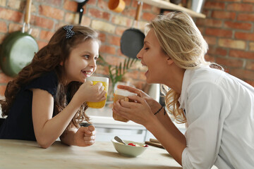 Mother and Daughter Enjoying Breakfast Together on a Sunny Morning