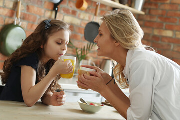 Mother and Daughter Enjoying Breakfast Together on a Sunny Morning