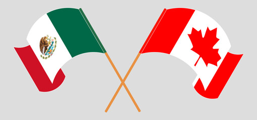 Crossed and waving flags of Mexico and Canada