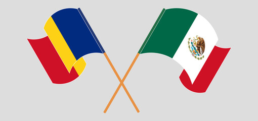 Crossed and waving flags of Romania and Mexico