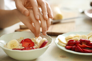 Preparing Fresh Strawberry and Banana Fruit Salad in a Bright Kitchen