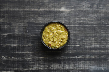 A Bowl Filled With Guacamole and Tortilla Chips