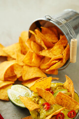Spicy Guacamole With Tortilla Chips and Fresh Ingredients on a Table