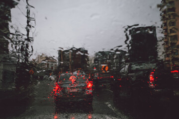 Shot from inside car moving on the road in rain with traffic jam