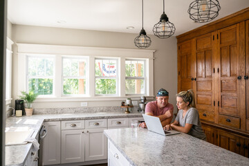 Marine veteran at home with family on a early morning in the kitchen.