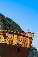 Day low angle view of abandoned rusted shipwreck with bow visible at Zakynthos island Greece,...