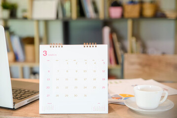 Calendar 2022 desk place on table. Desktop Calender for Planner to plan agenda, timetable, appointment, organization, management each date, month, and year on wooden office table.Calendar Concept.