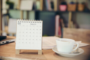 Deadline Date on calendar Concept. Desktop Calendar Desk for Planner to plan agenda event, timetable, appointment, organization, management each date, month, and year placed on wooden office table.