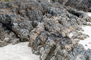 Exposed rock protrudes over sandy soil. Beautiful rocks.