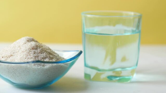  Psyllium Seeds in a glass container on table 