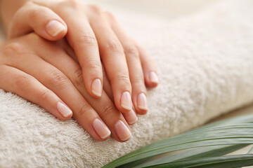 Beautiful woman hands with manicure isolated on light background.