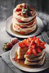 Sliced delicious sweet pamcakes with strawberries on the plate