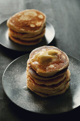 Healthy summer breakfast with classic pancakes with a slice of melted butter in the plate