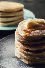 Healthy summer breakfast with classic pancakes with a slice of melted butter in the plate