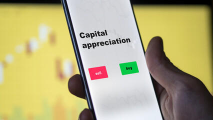 An investor's analyzing the capital appreciation etf fund on screen. A phone shows the ETF's prices capital appreciation to invest