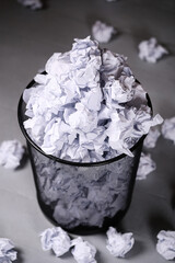 Top view of creased white paper balls in a trash can - obrazy, fototapety, plakaty