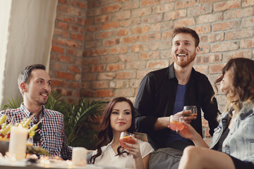 Friends drinking and having fun on the couch