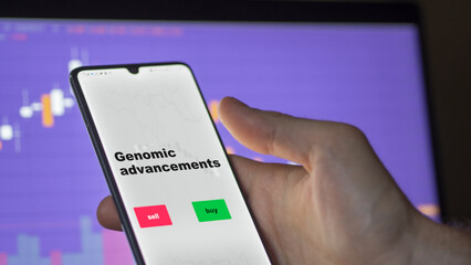 An investor's analyzing the genomic advancements etf fund on screen. A phone shows the ETF's prices stocks to invest