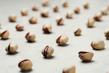 A number of delicious pistachios on a light background