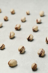 A number of delicious pistachios on a light background