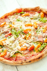 Picture of delicious hot whole pizza with vegetables on a wooden background