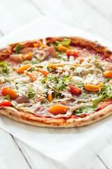 Close view of delicious hot whole pizza with vegetables 
