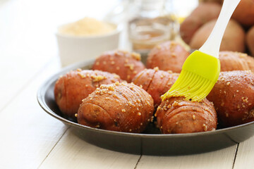 Delicious baked hot potato with spices on a wooden background