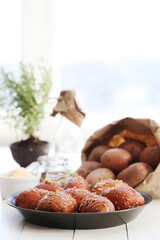 Delicious baked hot potato with spices on a wooden background