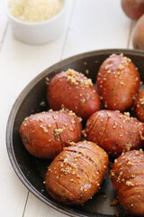 Delicious baked hot potato with spices on a wooden background