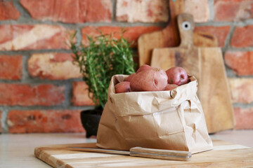 A bag of fresh raw potatoes in the kitchen